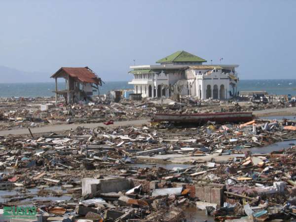 A mosque is left standing amid the rubble in Banda Aceh, post 2004 tsunami. Several mosques survived and may have been saved by the open ground floor that is part of their design. The tsunami waves reached the middle of the second floor.