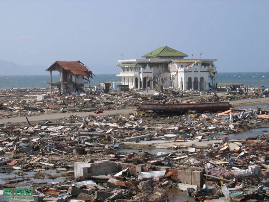 A mosque is left standing amid the rubble in Banda Aceh, post 2004 tsunami. Several mosques survived and may have been saved by the open ground floor that is part of their design. The tsunami waves reached the middle of the second floor.