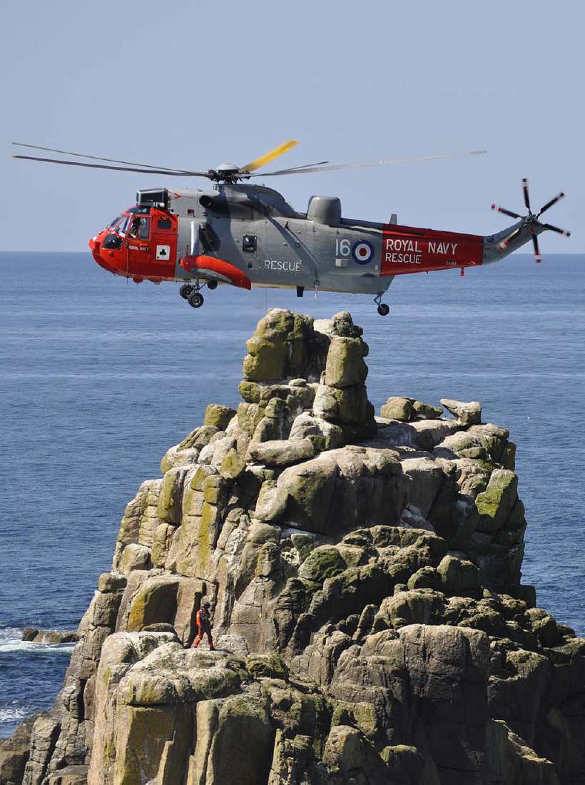 Royal Navy helicopter hovering close to land. [msaunder1972](http://www.shutterstock.com/gallery-482146p1.html?cr=00&pl=edit-00) / [Shutterstock.com](http://www.shutterstock.com/?cr=00&pl=edit-00)