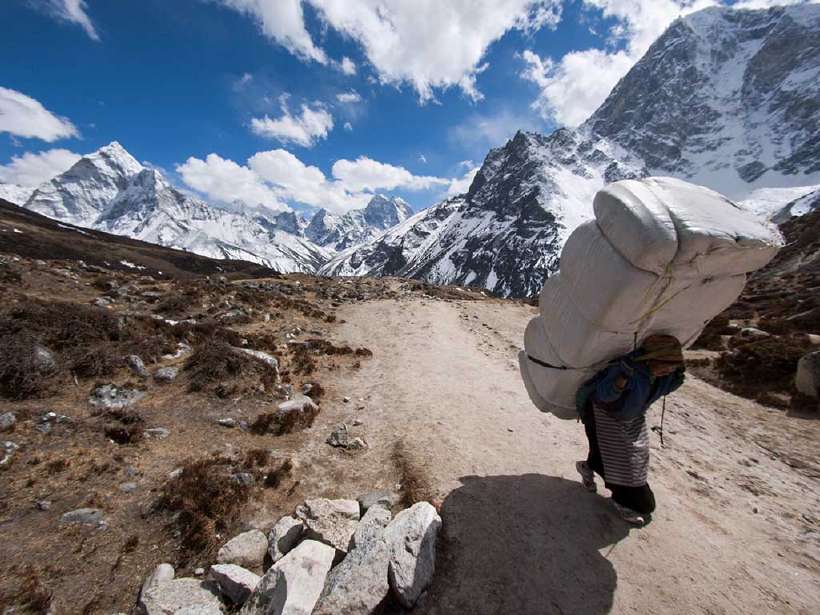 A Himalayan sherpa porter carries a large load uphill along the Everest Base Camp in Nepal. [R.M. Nunes](http://www.shutterstock.com/gallery-1870040p1.html?cr=00&pl=edit-00) / [Shutterstock.com](http://www.shutterstock.com/?cr=00&pl=edit-00)