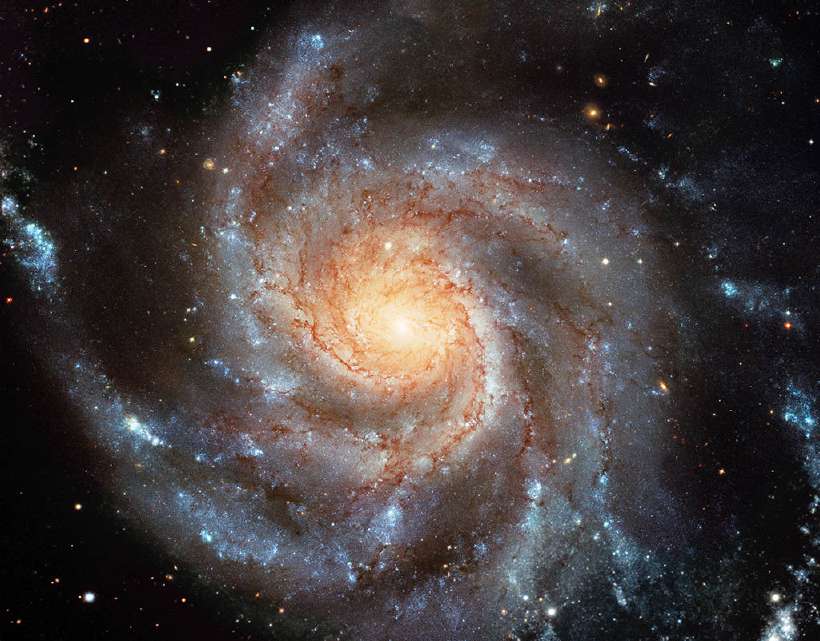 Giant spiral disk of stars, dust and gas is 170,000 light-years across. The spiral galaxy M101 is estimated to contain at least one trillion stars. [Cleaned and retouched image, original by ESA-Hubble]