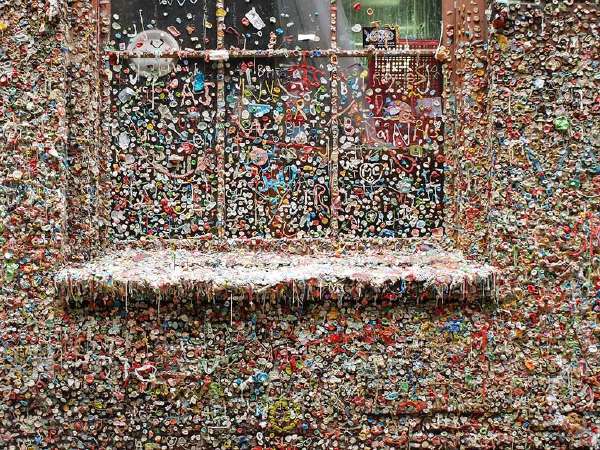 The Market Theater Gum Wall is a local landmark in downtown Seattle. This brick alleyway wall is covered in used chewing gum which is several inches thick at places.