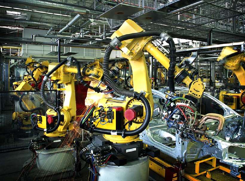 Robots on the factory floor, building a car