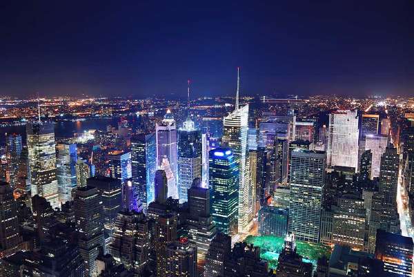 Aerial view of skyscrapers at night around Times Square, in Midtown Manhattan, New York City.