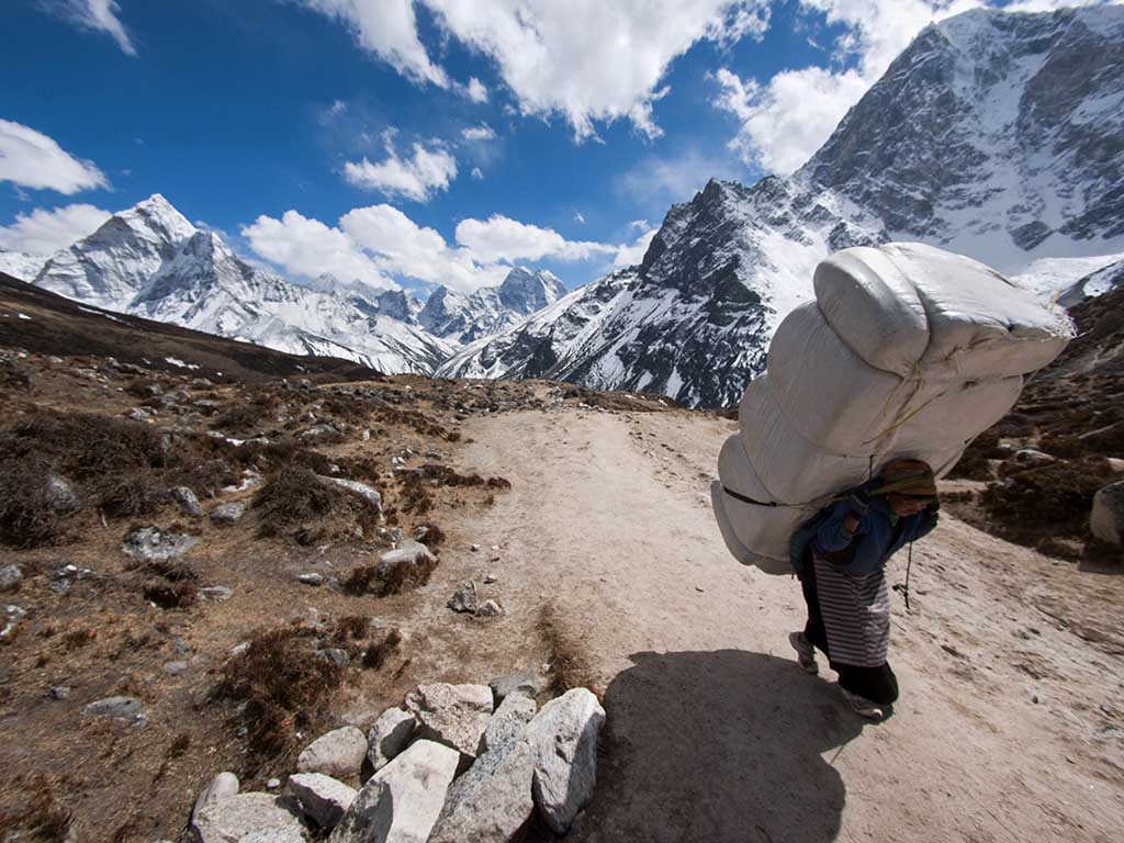 himalayan sherpa porter large load uphill