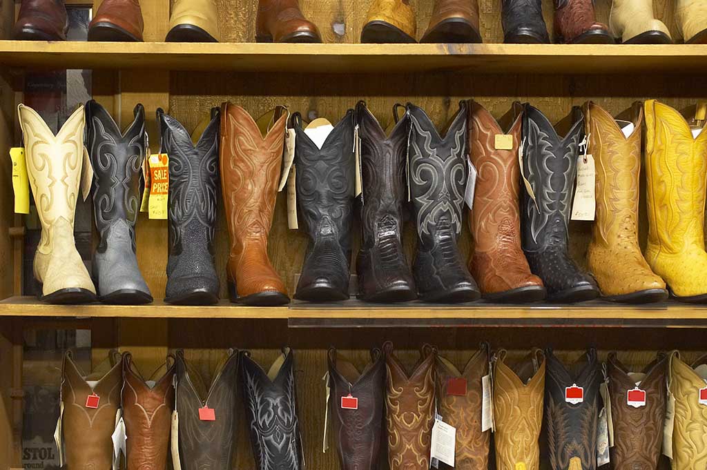 Shelf full of cowboy boots