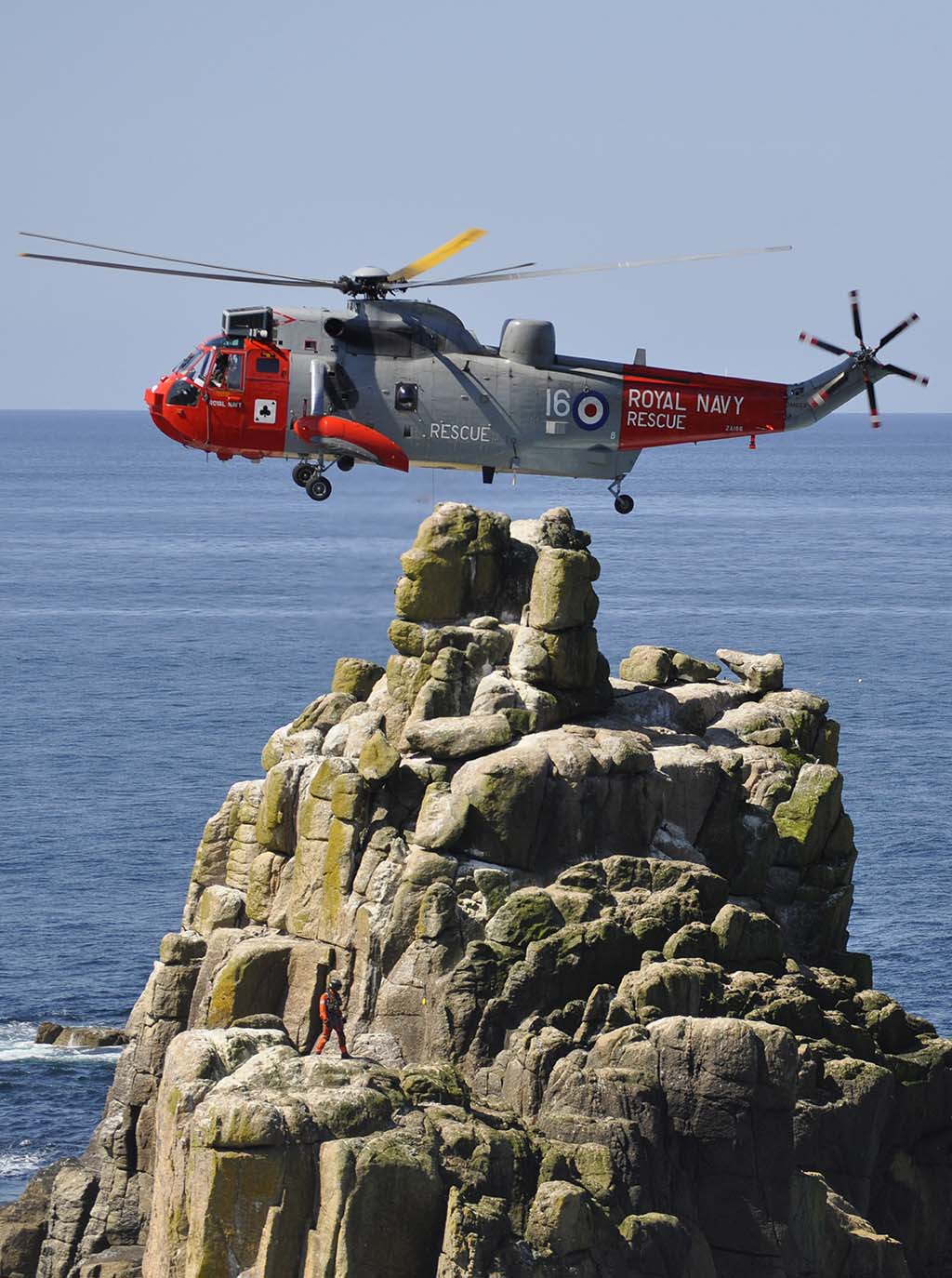 Royal Navy helicopter hovering close to land
